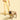 Dog wearing a yellow harness and leash on a light yellow background