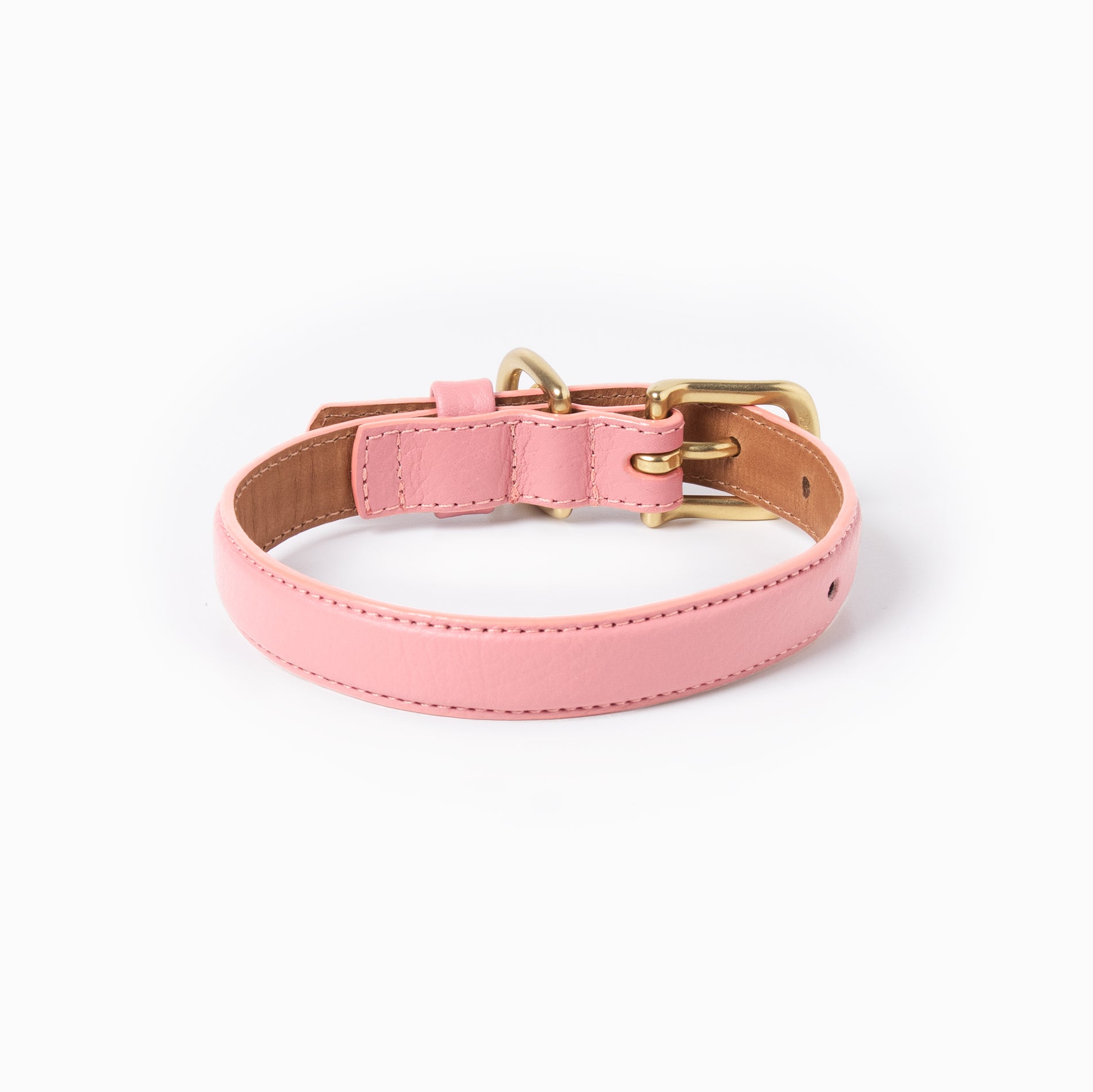 Back of pink leather dog collar with brass hardware